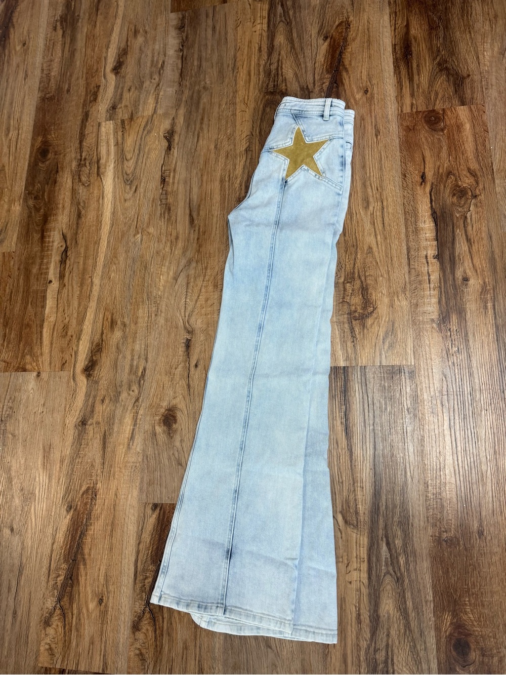 We The Free Light Wash Flare Jeans with Gold Star Accent